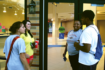 Delta State University students Leha Rhoda of Walls, Shelby James of Nesbit, Sherita Hampton of Oakland, and Josh Williams of Charleston visit in front of Foundation Hall. 